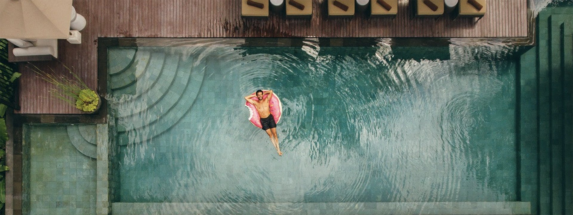 A man relaxing in a swimming pool