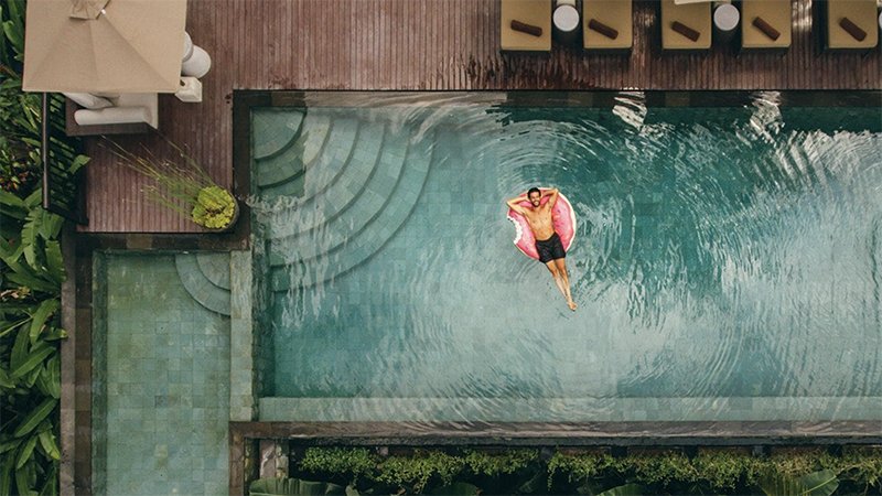 A man relaxing in a swimming pool