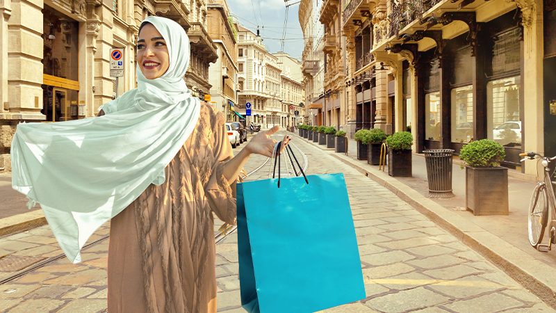 A woman in a sheila with shopping bags